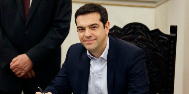 Greece's Prime Minister Alexis Tsipras poses for the photographers after taking a secular oath at the Presidential Palace in Athens, Monday, Jan. 26, 2015. Radical left leader Alexis Tsipras has been sworn in as Greece's new prime minister, becoming the youngest man to hold the post in 150 years. The 40-year-old broke with tradition and took a secular oath rather than the Greek Orthodox religious ceremony with which prime ministers are usually sworn in. (AP Photo/Thanassis Stavrakis)