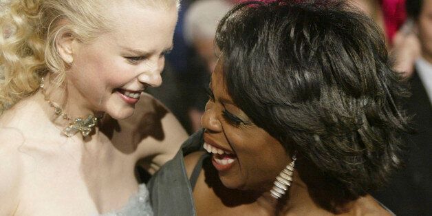 Nicole Kidman, left, and Oprah Winfrey laugh as they arrive at the Vanity Fair post-Oscar party, Sunday, Feb. 29, 2004, in the West Hollywood section of Los Angeles. (AP Photo/Chris Weeks)