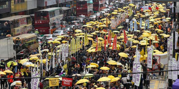 Thousands of pro-democracy activists take part in a democracy march to Central, demanding for universal suffrage in Hong Kong Sunday, Feb. 1, 2015. The march is the first large-scale demonstration since the Occupy Central protest ended last year as the government started a second round of public consultation on democratic reform. (AP Photo/Kin Cheung)
