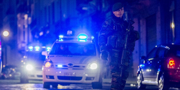 A Belgian security officer patrols near the Palace of Justice, where suspects wanted in Belgium on terrorism-related charges are set to appear before the federal court, in Brussels on Wednesday, Jan. 21, 2015. The suspects were picked up in an anti-terror sweep following a firefight in Verviers, in which two suspected terrorists were killed. (AP Photo/Geert Vanden Wijngaert)