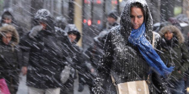 Pedestrians make their way through snow in New York, Monday, Jan. 26, 2015. More than 35 million people along the Philadelphia-to-Boston corridor rushed to get home and settle in Monday as a fearsome storm swirled in with the potential of 1 to 3 feet of snow that could paralyze the Northeast for days. (AP Photo/Seth Wenig)