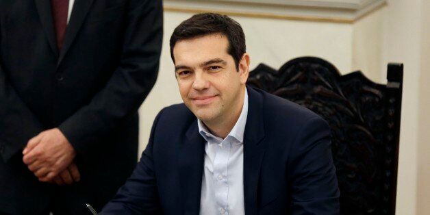 Greece's Prime Minister Alexis Tsipras poses for the photographers after taking a secular oath at the Presidential Palace in Athens, Monday, Jan. 26, 2015. Radical left leader Alexis Tsipras has been sworn in as Greece's new prime minister, becoming the youngest man to hold the post in 150 years. The 40-year-old broke with tradition and took a secular oath rather than the Greek Orthodox religious ceremony with which prime ministers are usually sworn in. (AP Photo/Thanassis Stavrakis)