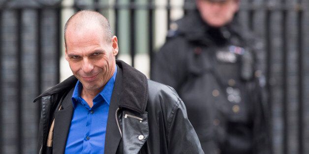 Yanis Varoufakis, Greece's finance minister, left, passes a police officer as he arrives for his meeting with George Osborne, U.K. chancellor of the exchequer, at 11 Downing Street in London, U.K., on Monday, Feb. 2, 2015. Varoufakis said his country won't take any more aid under its existing bailout agreement and wants a new deal with its official creditors by the end of May. Photographer: Jason Alden/Bloomberg via Getty Images