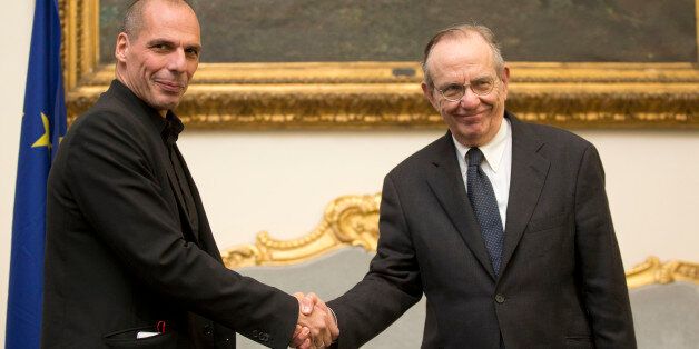 Greece's finance minister, Yanis Varoufakis, left, shakes hands with his Italian counterpart Pier Carlo Padoan during a photo opportunity prior to the start of their meeting in Rome, Tuesday, Feb. 3, 2015. Hopes for a deal between Greece and its European creditors got a boost after the country's new government backed away from demands to write off a chunk of its bailout loans, a prospect that had horrified creditors and investors. Tsipras and Varoufakis arrived in Italy on Tuesday, for talks wit