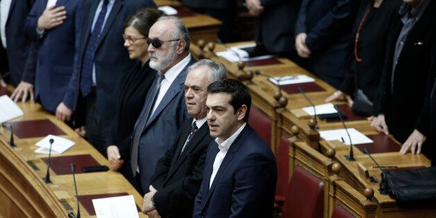 Greece's Prime Minister Alexis Tsipras takes a secular oath at the first convention of Parliament since the Jan. 25 elections in Athens on Thursday, Feb. 5, 2015. Non Greek Orthodox lawmakers were sworn in with a secular, or Muslim version of the oath. Jittery investors dumped Greek shares Thursday after the European Central Bank tightened the screws on the country's banking system, piling pressure on the new anti-austerity government to seek a compromise with bailout creditors. (AP Photo/Yannis