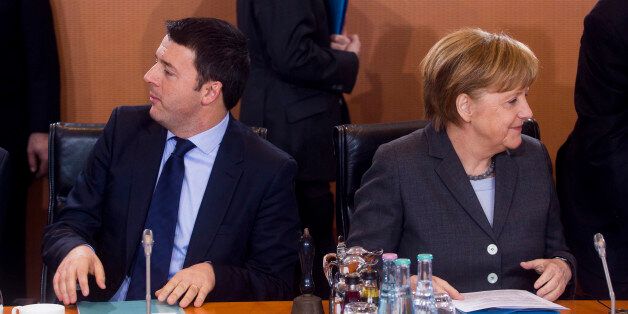 BERLIN, GERMANY - MARCH 17: German Chancellor Angela Merkel (R) and Italian Prime Minister Matteo Rentzi pictured at the plenary meeting during German and Italian government consultations at the Chancellery on March 17, 2014 in Berlin, Germany. This is the first meeting of its kind between the two governments since Renzi took office in February. (Photo by Jochen Zick-Pool/Getty Images)