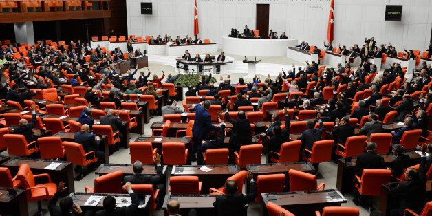 ANKARA, TURKEY - OCTOBER 2: Turkish lawmakers authorize the government to deploy troops to Syria and Iraq to fight any group threatening the country on October 2, 2014 at Turkish Grand National Assembly in Ankara, Turkey. The motion, submitted by Turkey's Prime Minister Ahmet Davutoglu's Cabinet and received support from 298 members of the 550-seat Parliament, with 98 voting against, will be in effect for one year. (Photo by Halil Sagirkaya/Anadolu Agency/Getty Images)