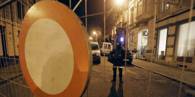 A Belgian police officer guards a street in Verviers, Belgium, Friday, Jan. 16, 2015. Belgian authorities say two people have been killed and one has been arrested during a shootout in an anti-terrorist operation in Verviers. (AP Photo/Frank Augstein)