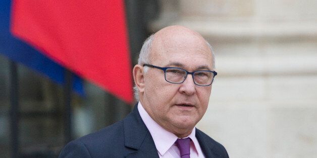 French Finance Minister, Michel Sapin, leaves the Elysee Palace following the weekly cabinet meeting in Paris on Wednesday Dec. 3, 2014. Sapin predicts that spending cuts and higher tax revenue will help lower its budget deficit next year. (AP Photo/Jacques Brinon)