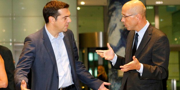 President of Greek SYRIZA party Alexis Tsipras and Director of European Central Bank Joerg Asmussen, from left, share a word after a meeting at the ECB in Frankfurt, Germany, Thursday, Sept.19, 2013. (AP Photo/Michael Probst)