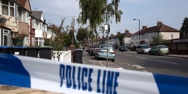 LONDON, ENGLAND - SEPTEMBER 05: (EDITORS NOTE: Number plate has been pixelated) The police cordon near a property in Edmonton where a woman is thought to have been beheaded yesterday, on September 5, 2014 in London, England. The body of 82-year-old Palmira Silva was discovered yesterday in a rear garden of a house on Nightingale Road. A 25-year-old man was arrested on suspicion of murder and is being held under police guard in hospital. (Photo by Oli Scarff/Getty Images)