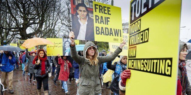 People take part in a protest by Amnesty International, for the immediate release of the Saudi blogger Raif Badawi, in front of the Saudi Embassy in The Hague, on January 15, 2015. Badawi put on the website 'Freed Saudi liberals 'and was arrested in 2012. He was sentenced to ten years in prison, converted 226,000 euro fine and a thousand lashes. AFP PHOTO / ANP / MARTIJN BEEKMAN ***netherlands out*** (Photo credit should read Martijn Beekman/AFP/Getty Images)