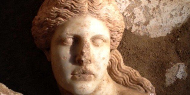 This picture provided by Greece's Culture Ministry on Tuesday, Oct. 21, 2014 shows the broken marble head of one of the two sphinx statues that decorated the entrance of a large ancient tomb under excavation at Amphipolis, in northern Greece. The ministry said the head was discovered in the third and deepest chamber of the late 4th century B.C. tomb, which archaeologists claim is unplundered. Although not all of the tomb has yet been dug, so far workers have uncovered the two headless sphinxes, a pair of larger-than-life-sized female statues and an ornate mosaic floor depicting the abduction of the ancient goddess Persephone. No burial has been found yet and it is unclear who the tomb was built for, with most archaeologists proposing a senior official in the entourage of the ancient Greek warrior-king Alexander the Great. (AP Photo/Greek Culture Ministry)