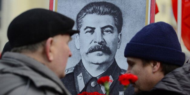 MOSCOW, RUSSIA - DECEMBER 21: Russians lay flowers at Joseph Stalin's memorial during a commemoration of 135th birth anniversary of the Soviet leader Stalin at Red Square in Moscow, Russia on December 21, 2014. (Photo by Sefa Karacan/Anadolu Agency/Getty Images)