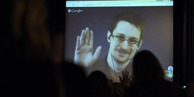 Edward Snowden greets the audience before he is honoured with the Carl von Ossietzky medal by International...
