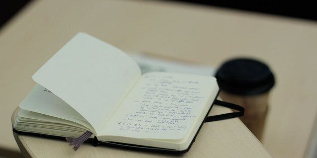notebook with paper coffee cup on a desk. 120115-25