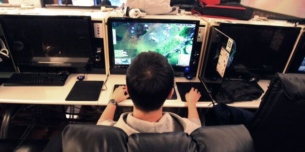 Shin Minchul, a 21-year-old college student, plays online computer games at an Internet cafe in Seoul, South Korea, Wednesday, Dec. 11, 2013. A law under consideration in South Korea's parliament has sparked vociferous debate by grouping popular online games such as