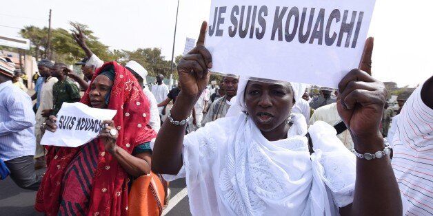 Women holding placards reading 'I am Kouachi', refering to the Kouachi brothers, the French gunmen who killed 12 people at France's Charlie Hebdo magazine on January 7, 2015, demonstrate near the Dakar Grand Mosque after the Friday prayer on January 16, 2015 to protest against a new cartoon of the Prophet Mohammed published by French magazine Charlie Hebdo on January 14. The Senegalese government had earlier banned the dissemination of the January 14 edition of the satirical French weekly Charli