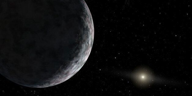 This artist's concept, released by NASA, shows the planet catalogued as 2003UB313 at the lonely outer fringes of our solar system. Our Sun can be seen in the distance. The new planet, which is yet to be formally named, is at least as big as Pluto and about three times farther away from the Sun than Pluto. It is very cold and dark. The planet was discovered by the Samuel Oschin Telescope at the Palomar Observatory near San Diego, Calif. (AP Photo/NASA, Caltech)