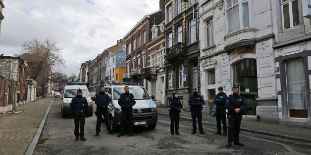 Belgian police officers guard a street in Verviers, Belgium, Friday, Jan. 16, 2015. Police blocks a street after security forces took part in anti-terrorist raids in Verviers, eastern Belgium. Belgian authorities say two people have been killed and one has been arrested during a shootout in an anti-terrorist operation in the eastern city of Verviers. (AP Photo/Frank Augstein)