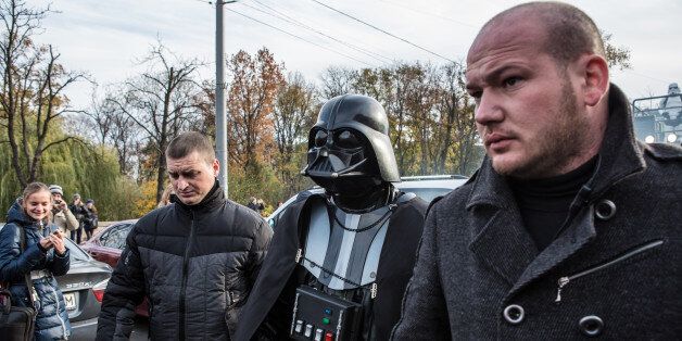 KIEV, UKRAINE - OCTOBER 24: Ukrainian parliamentary candidate Darth Viktorovich Vader (L) walks with other representatives of the Internet Party of Ukraine dressed as characters from Star Wars in central Kiev on October 24, 2014 in Kiev, Ukraine. The country's parliamentary elections, scheduled for Sunday, are seen as key to President Petro Poroshenko's ability to advance his agenda, stabilize the economy, and end fighting in the country's east. (Photo by Brendan Hoffman/Getty Images)