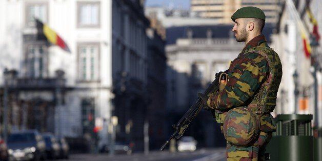 A Belgian soldier stands gyard outside the US Embassy in Brussels on January 17, 2015 after security forces smashed a suspected Islamist 'terrorist' cell planning to kill police officers. Up to 300 soldiers will be progressively deployed in the capital Brussels and the northern city of Antwerp, which has a large Jewish population, Prime Minister Charles Michel's office said in a statement. Security forces early on January 16 killed two suspected Islamists in a huge raid in the eastern city of Verviers on an alleged jihadist cell planning to attack police in the country, and police arrested 13 people during a series of following raids across Belgium. AFP PHOTO / BELGA / NICOLAS MAETERLINCK **Belgium Out** (Photo credit should read NICOLAS MAETERLINCK/AFP/Getty Images)