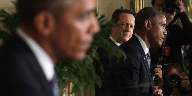 WASHINGTON, DC - JANUARY 16: Seen as reflected on a mirror, U.S. President Barack Obama (R) and British Prime Minister David Cameron (2nd L) participate in a joint news conference at the East Room of the White House January 16, 2015 in Washington, DC. The two leaders had an Oval Office meeting earlier discussing bilateral issues including economic growth, international trade, cybersecurity, Iran, ISIL, counterterrorism, Ebola, and Russias actions in Ukraine. (Photo by Alex Wong/Getty Images)
