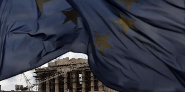 An EU flag waves in front of the ancient temple of Parthenon atop the Acropolis hill in Athens on January 13, 2015. Greece could exit the euro by accident, Finance Minister Gikas Hardouvelis said in a new warning of what could happen if anti-austerity leftist party Syriza wins the election later this month. AFP PHOTO / ARIS MESSINIS (Photo credit should read ARIS MESSINIS/AFP/Getty Images)
