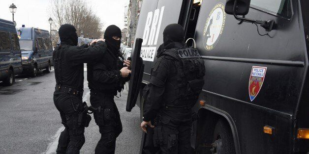 Members of the French national police intervention group (BRI) prepare their gears before leaving on operation in front of Paris' police headquarters on January 8, 2015, a day after Islamist gunmen stormed the office of satirical magazine Charlie Hebdo, killing eight journalists, two police and two others. The men are still thought to be on the run, and there has so far been no claim of responsibility for the massacre that has deeply shocked France. AFP PHOTO / ERIC FEFERBERG (Photo cr