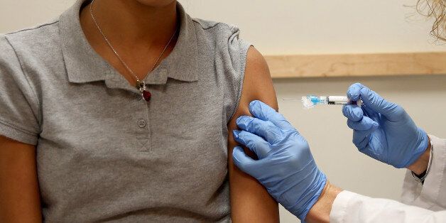 CORAL GABLES, FL - JANUARY 07: Doralissa Villaman,15, receives a flu vaccination from pediatrician Dr. Amanda Porro M.D. during a visit to the Miami Children's Hospital on January 7, 2015 in Coral Gables, Florida. The Centers for Disease Control and Prevention announced that in the United States the virus that causes the flu is particularly bad this year and has hit most parts of the United States, with 43 states experiencing 'widespread' flu activity and six others reporting 'regional' flu ac