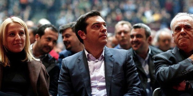 Alexis Tsipras, leader of the Syriza party, center, listens to a speaker during a pre-election party congress in Athens, Greece, on Saturday, Jan. 3, 2014. Greece's political parties embarked on a flash campaign for elections in less than three weeks that Prime Minister Antonis Samaras said will determine the fate of the countrys membership in the euro currency area. Photographer: Kostas Tsironis/Bloomberg via Getty Images