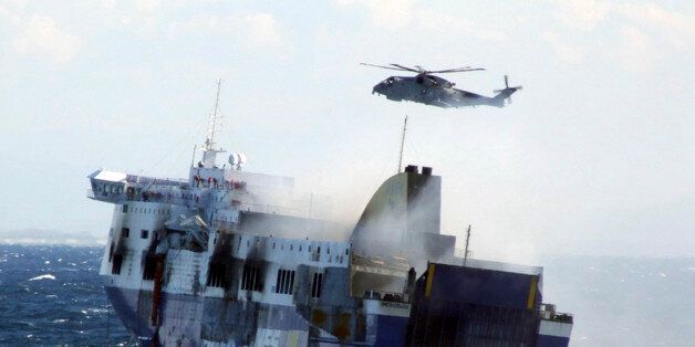 In this image released by the Italian Navy, smoke billows from the Italian-flagged Norman Atlantic that caught fire in the Adriatic Sea, Monday, Dec. 29, 2014. Fighting high winds and stormy seas, helicopter rescue crews on Monday evacuated the last of hundreds of people trapped aboard a Greek ferry that caught fire off Albania. The death toll climbed to eight as survivors told of a frantic rush to escape the flames and pelting rain. The evacuation of the ferry was completed in the early afterno