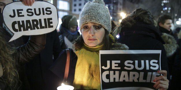 MOSCOW, RUSSIA - JANUARY 07: People hold banners and posters to show reactions against gun attack on the building of French magazine 'Charlie Hebdo' in Paris, leaving 12 dead, during the protest at Manhattan's Union Square in New York, United States on January 07, 2015. (Photo by Bilgin S. Sasmaz/Anadolu Agency/Getty Images)