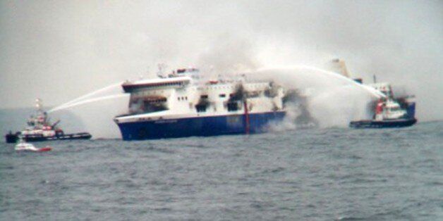 In this photo taken from a nearby ship, vessels try to extinguish the fire at the Italian-flagged Norman Atlantic after it caught fire in the Adriatic Sea, Sunday, Dec. 28, 2014. Italian and Greek military and coast guard rescue crews battled gale-force winds and massive waves Sunday as they struggled to rescue hundreds of people trapped on a burning ferry adrift between Italy and Albania. At least one person died and two were injured. The Italian Defense Ministry said 165 of the 478 people on t