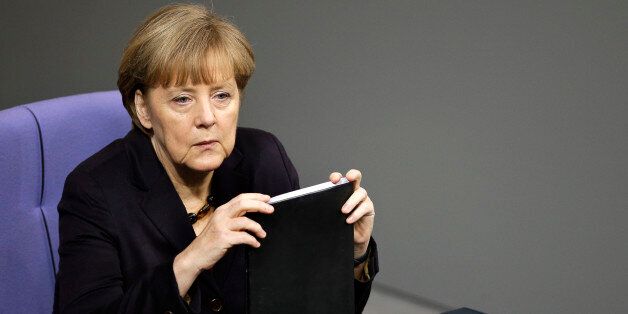 German Chancellor Angela Merkel attends a meeting of the German federal parliament, Bundestag, in Berlin, Germany, Thursday, Dec. 18, 2014. (AP Photo/Michael Sohn)