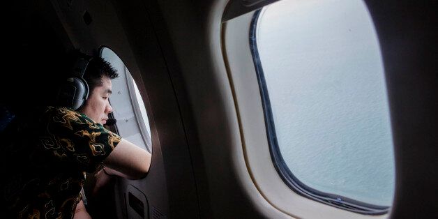 SURABAYA, INDONESIA - DECEMBER 30: A relative of a passenger looks out over the waters of the Java Sea near Pangkalan Bun, Kalimantan on December 30, 2014 in Surabaya, Indonesia. Debris and dead bodies have reportedly been sighted in the Java Sea during search operations for the missing AirAsia flight QZ 8501. AirAsia flight QZ8501 from Surabaya to Singapore, with 162 people on board, lost contact with air traffic control at 07:24 a.m. local time on December 28. (Photo by Ulet Ifansasti/Getty Im