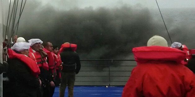 In this image taken from a Dec. 28, 2014 video and made available Wednesday, Dec. 31, 2014 passengers of the Italian-flagged ferry Norman Atlantic wait to be lifted from the deck by a rescue helicopter after it caught fire in the Adriatic Sea. More than 400 people were rescued from the ferry, most in daring, nighttime helicopter sorties that persisted despite high winds and seas, after a fire broke out before dawn Sunday on a car deck. Both Italian and Greek authorities have announced criminal investigations into the cause of the blaze. Italian authorities warned Tuesday that more bodies will likely be found when the blackened hulk of a Greek ferry is towed to Italy, as part of a criminal investigation into the fire that engulfed the ship at sea, killing at least 11 of the more than 400 people on board. (AP Photo/APTN)