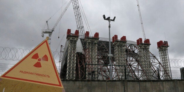 A gigantic steel arch under construction to cover the remnants of the exploded reactor at the Chernobyl nuclear power plant, in Chernobyl, Ukraine, on Sunday, Aug. 25, 2013, the scene of the world's worst nuclear accident. (AP Photo/Efrem Lukatsky)