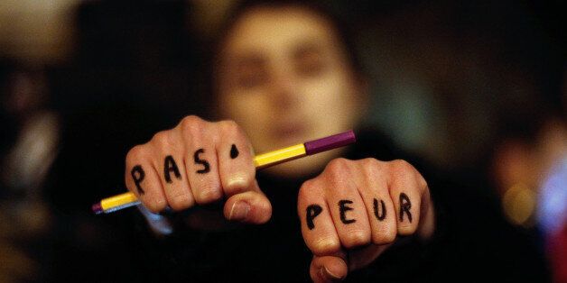 A woman holds up her hands bearing the words