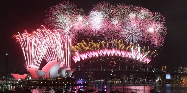 Fireworks explode over the Opera House and the Harbour Bridge during New Years Eve celebrations in Sydney, Australia, Thursday, Jan. 1, 2015. Thousands of people crammed into Lady Macquaries Chair look-out to see the new year in and watch the annual fireworks show. (AP Photo/Rob Griffith)