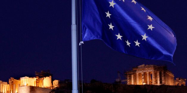 The European Union flag flutters in the wind with the ancient Parthenon temple, right, and the Propylaea, left, at the Acropolis Hill, in Athens on Tuesday, Oct. 25, 2011. Prime Minister George Papandreou called for unity across Greece's political spectrum Tuesday, as European officials struggled to come up with a definitive solution to Greece's debt woes and prevent it from dragging down other EU nations.(AP Photo/Petros Giannakouris)
