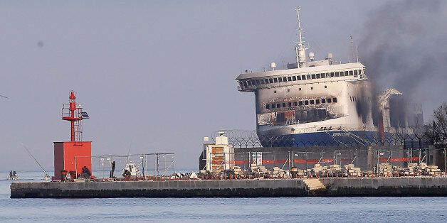 Smoke billows from the Italian-flagged Norman Atlantic ferry after that was towed into the port of Brindisi, southern Italy, Saturday, Jan. 3, 2015. For a second day, fierce heat from a slow-burning blaze kept firefighters and other investigators on Saturday from searching the hold and vehicle decks of a Greek ferry for more bodies. At least 11 people perished in the pre-dawn blaze on Dec. 28 aboard the Norman Atlantic, on a voyage between Greece and Italy. Authorities fear more bodies might be inside the vehicle deck where the fire began. (AP Photo/Antonio Calanni)