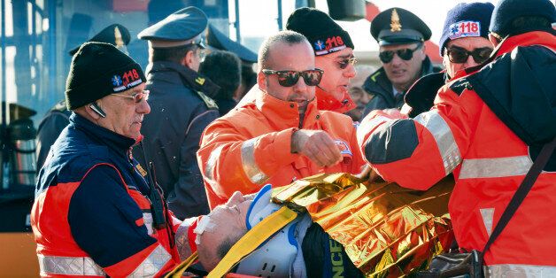 An injured passenger is being carried on a stretcher as he and some 40 of the survivors of the Norman Atlantic ferry fire, finally stepped ashore, in the port of Taranto, Italy, Wednesday, Dec. 31, 2014. They arrived by one of the cargo ships that took aboard passengers from the flaming, smoke-shrouded ferry in the first hours after the blaze down in the car deck sent people, shaken out of their sleep, to scrambling for their lives and take shelter -- in freezing cold, pelted by rain and buffete