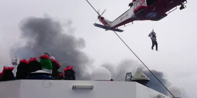 In this image taken from a Dec. 28, 2014 video and made available Wednesday, Dec. 31, 2014 a person is lifted from the deck of the Italian-flagged ferry Norman Atlantic by a rescue helicopter after it caught fire in the Adriatic Sea. More than 400 people were rescued from the ferry, most in daring, nighttime helicopter sorties that persisted despite high winds and seas, after a fire broke out before dawn Sunday on a car deck. Both Italian and Greek authorities have announced criminal investigations into the cause of the blaze. Italian authorities warned Tuesday that more bodies will likely be found when the blackened hulk of a Greek ferry is towed to Italy, as part of a criminal investigation into the fire that engulfed the ship at sea, killing at least 11 of the more than 400 people on board. (AP Photo/APTN)