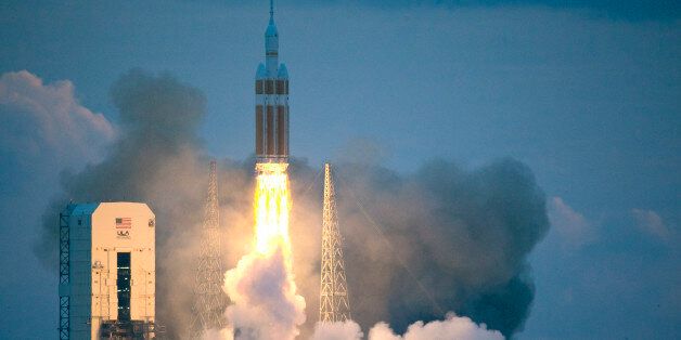 The NASA Orion space capsule atop a Delta IV rocket, in its first unmanned orbital test flight, lifts off from the Space Launch Complex 37B pad at the Cape Canaveral Air Force Station, Friday, Dec. 5, 2014, in Cape Canaveral, Fla. (AP Photo/John Raoux)