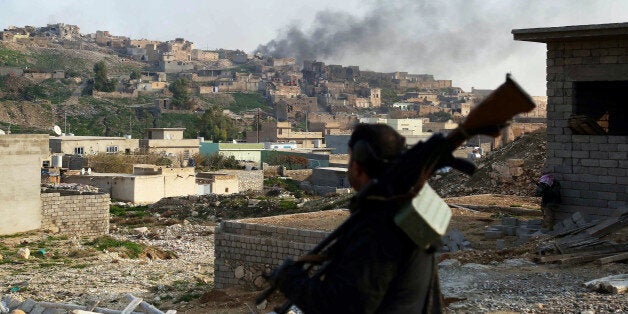 MOSUL, IRAQ - DECEMBER 21: Smoke rises during the clashes between Peshmerga forces and Islamic State of Iraq and Levant (ISIL) fighters in Sinjar district of Mosul, Iraq on December 21, 2014. Peshmerga forces stage attacks against ISIL to liberate ISIL occupied Sinjar. (Photo by Emrah Yorulmaz/Anadolu Agency/Getty Images)