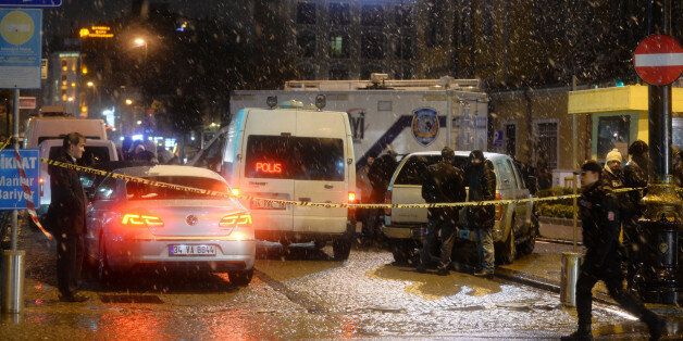Turkish security gather outside a police station where one police officer was killed and another injured after a suicide bomber blew herself up in Istanbul, Turkey, Tuesday, Jan. 6, 2015. Istanbul governor Vasip Sahin said the woman entered the police station and reported a missing wallet before detonating a bomb. The attack occurred in the Sultan Ahmet district, a popular tourist destination. (AP Photo)