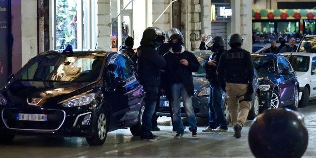 French police stand near the site where two people are being held hostage in a jewellery store by a gunman attempting a robbery on January 9, 2015 in Montpellier, southern France. A gunman robbed a jewellery store in the southern French city of Montpellier on on January 9, taking two hostages, a judicial source said, adding the incident 'had no link' to the twin hostage dramas around Paris. AFP PHOTO / STRINGER (Photo credit should read STRINGER/AFP/Getty Images)