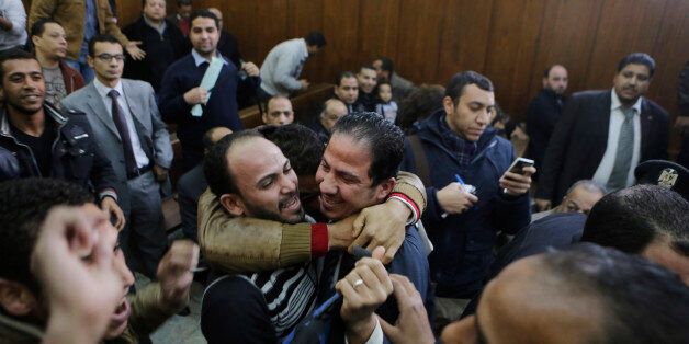 Relatives of 26 men who were arrested in a televised raid last month by police looking for gays at a Cairo public bathhouse, celebrate after an Egyptian court acquitted them in Cairo, Egypt, Monday, Jan. 12, 2015. The trial, which had caused an uproar among activists and rights groups, captured public attention after a pro-government TV network aired scenes of half-naked men being pulled from the bathhouse by police.(AP Photo/Amr Nabil)