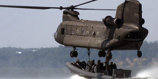 This photo, supplied by the U,S.Navy, shows a Special Warfare Combatant Craft (SWCC) crew, assigned to Special Boat Teams 12 and 20, attach a naval special warfare 11-meter rigid-hull inflatable boat to an Army Reserve CH-47 Chinook helicopter during a training exercise at Ft. Eustis Army Base,at Newport News, Va., on July 16, 2008. The units, were mainly used to deliver Navy SEALs onto foreign shores in the past, but now are called on to do other duties too. Slinging the special operations c